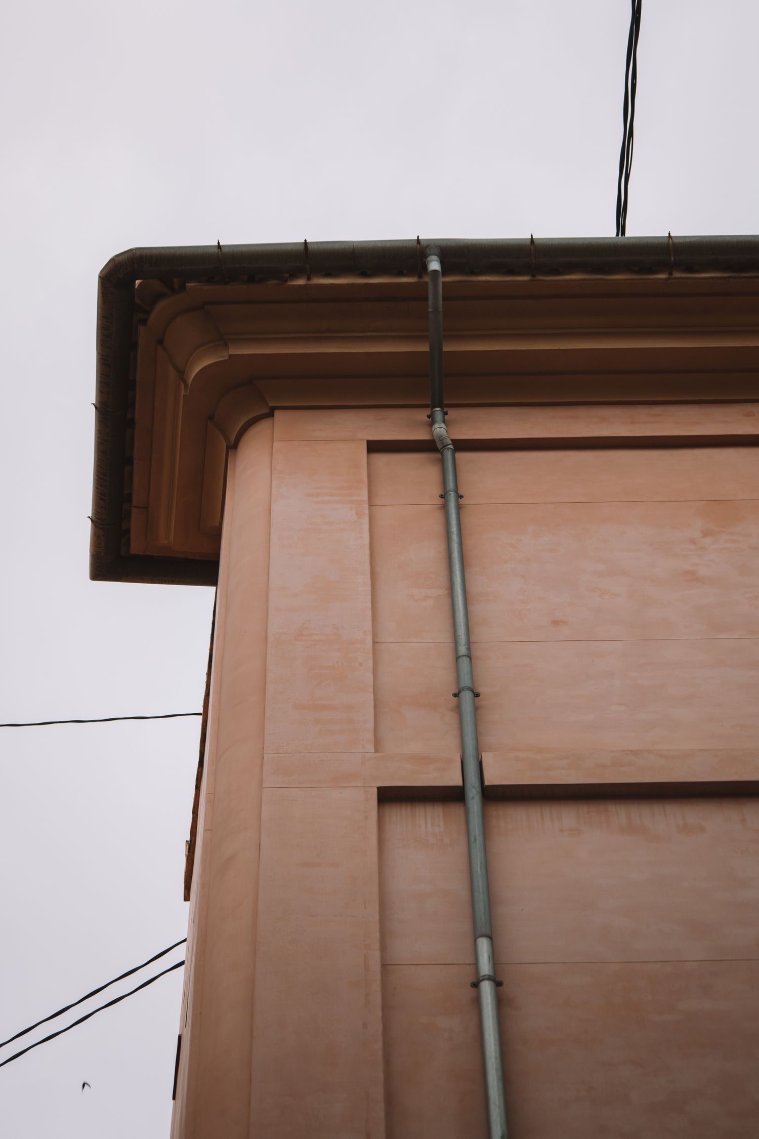 Descente et gouttière en zinc sur une façade, travail de zinguerie
